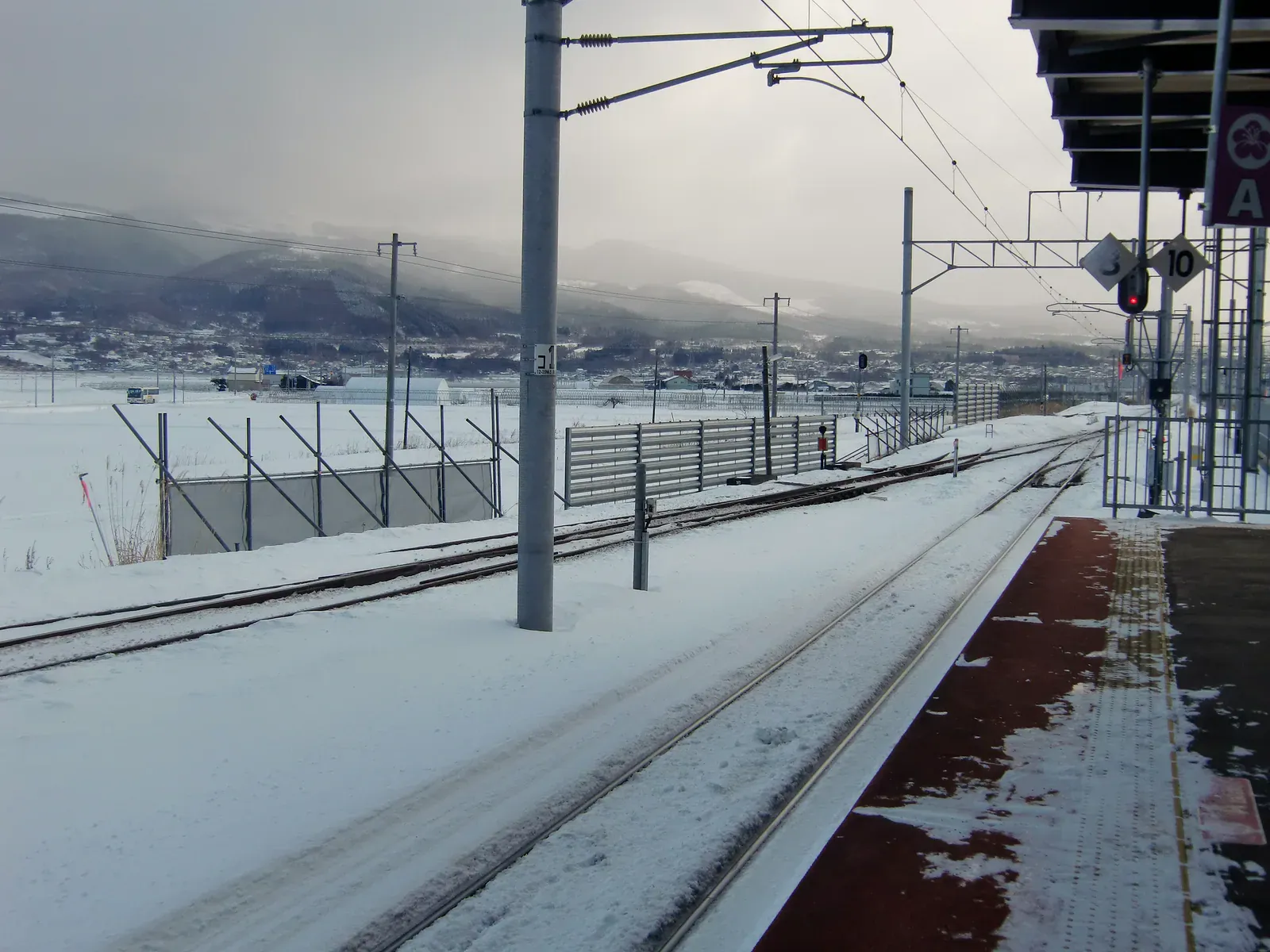 A train crossing snowy fields in Hokkaido