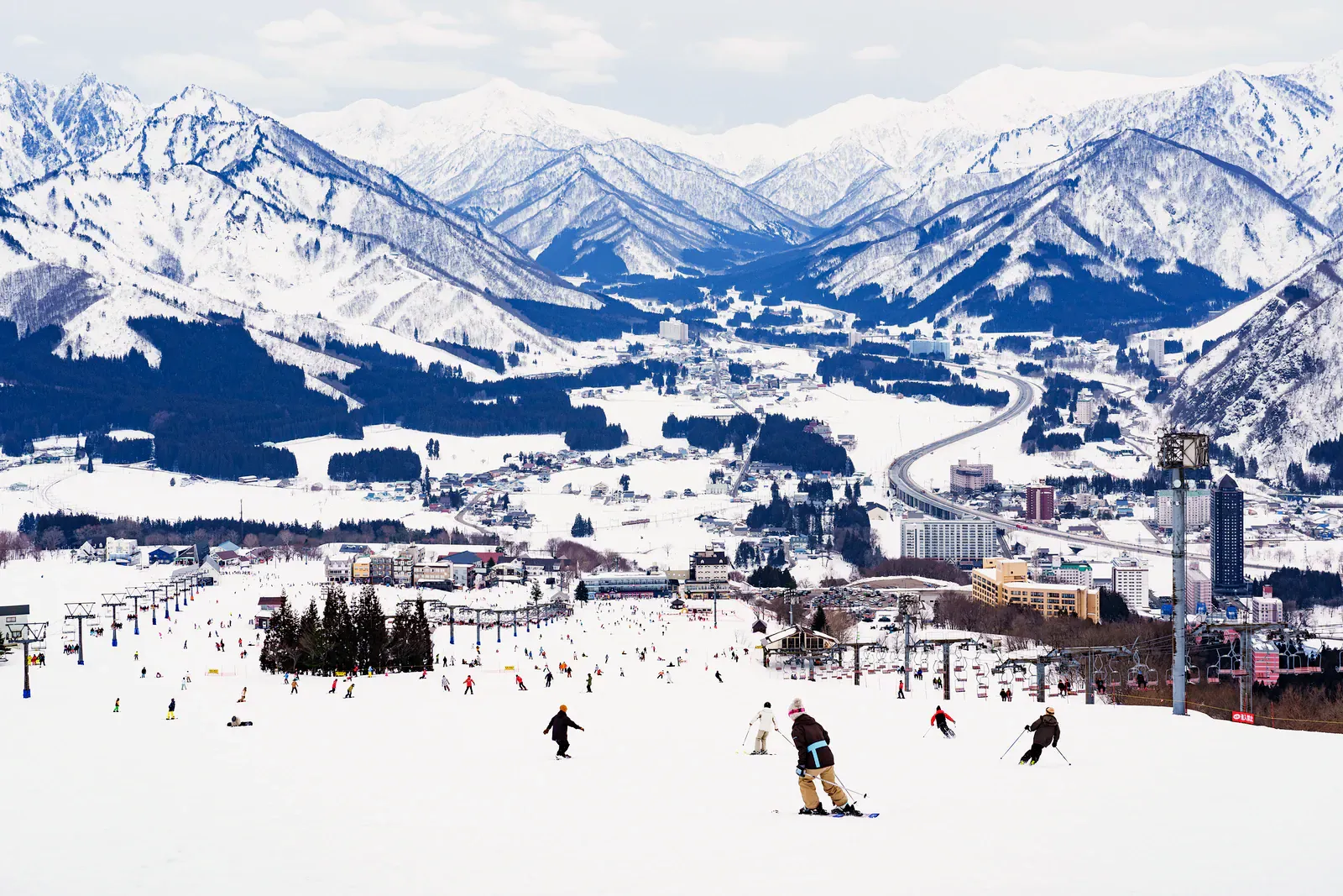 Ski resort village and slopes below Japanese Alps peaks