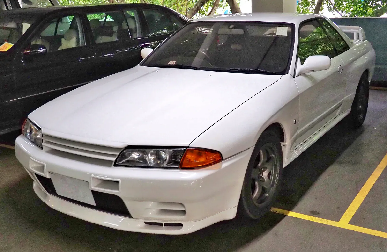 White Nissan Skyline GT-R R32 parked in a garage bay