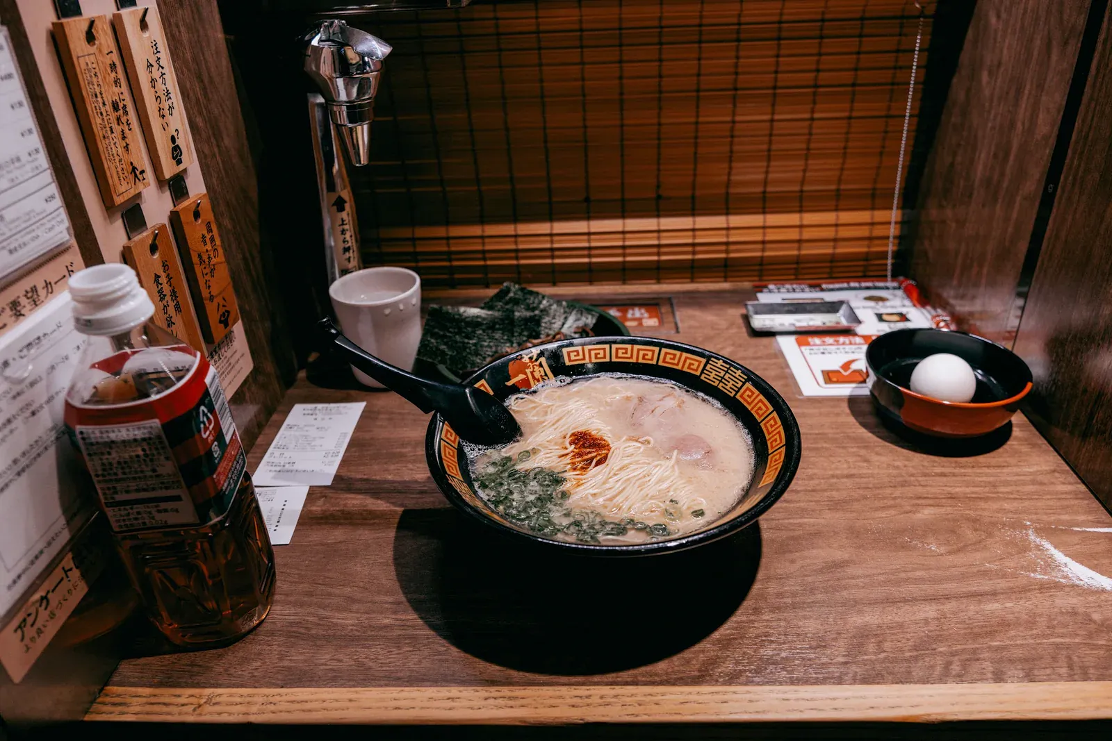 A bowl of ramen on a wooden counter
