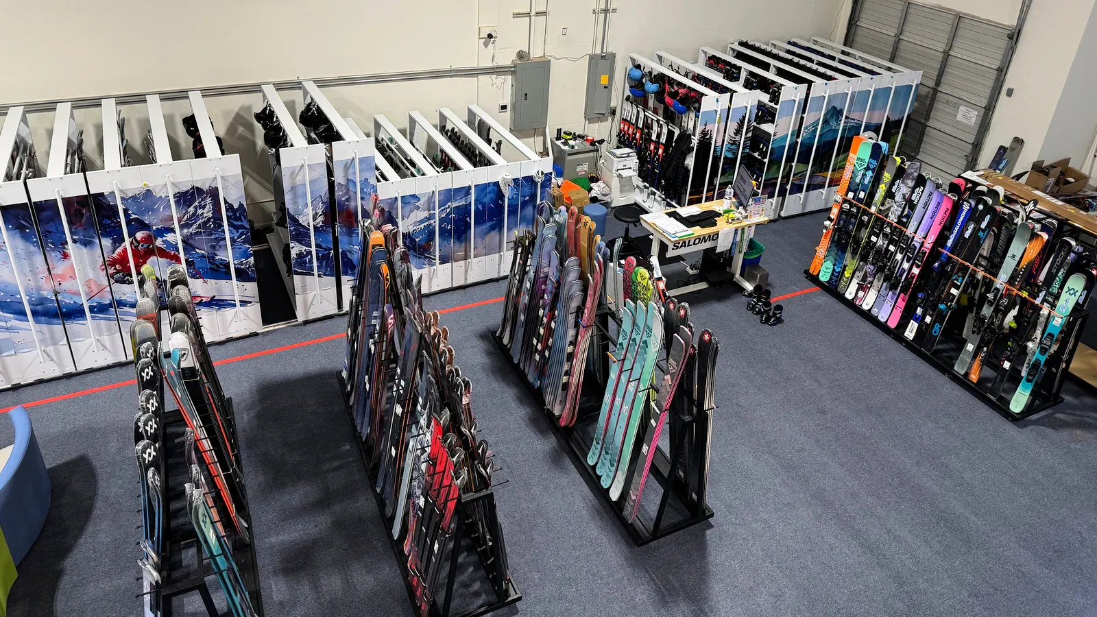 Ski and snowboard rental shop with rows of equipment