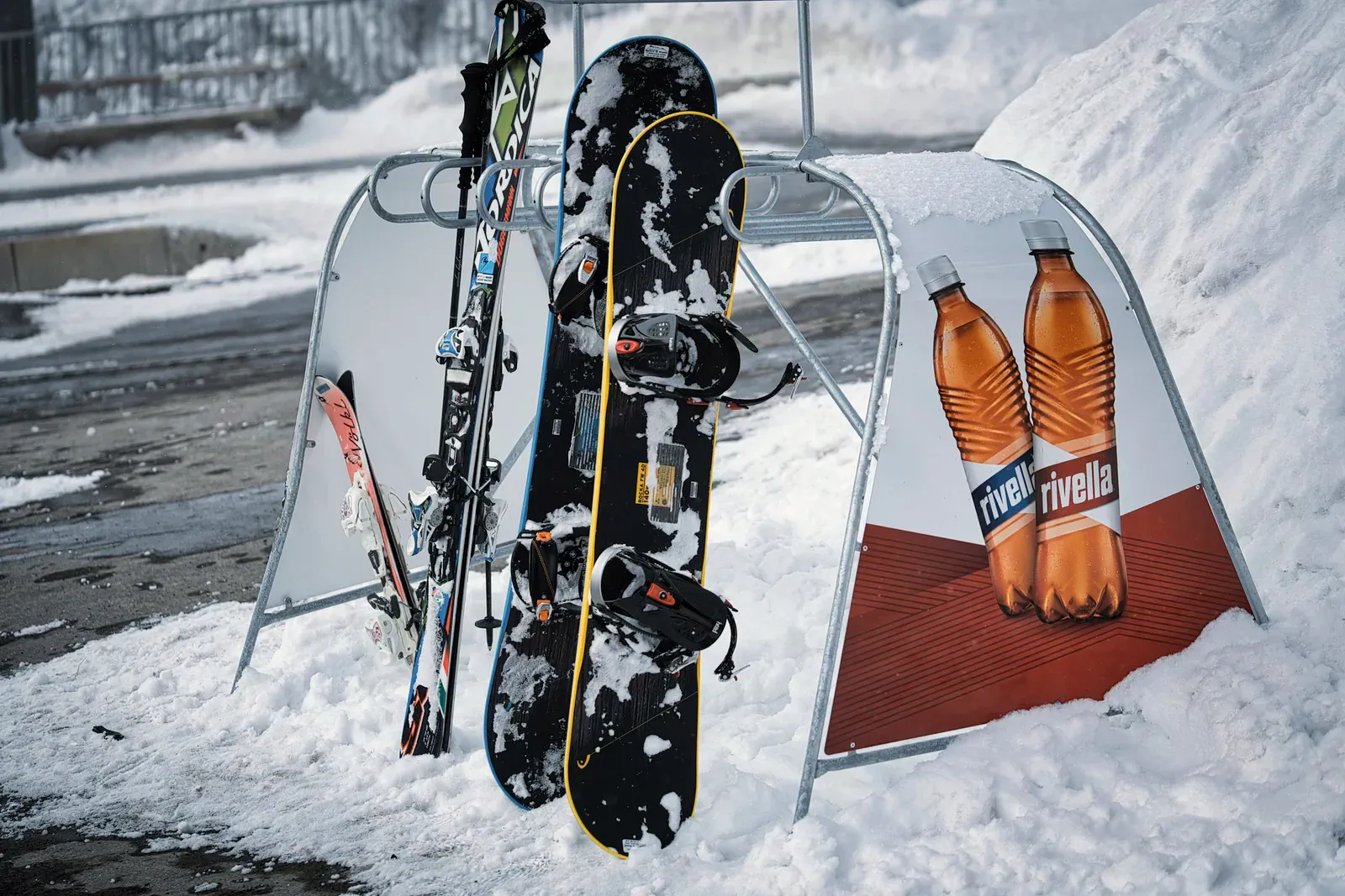 Snowboards and skis standing in snow