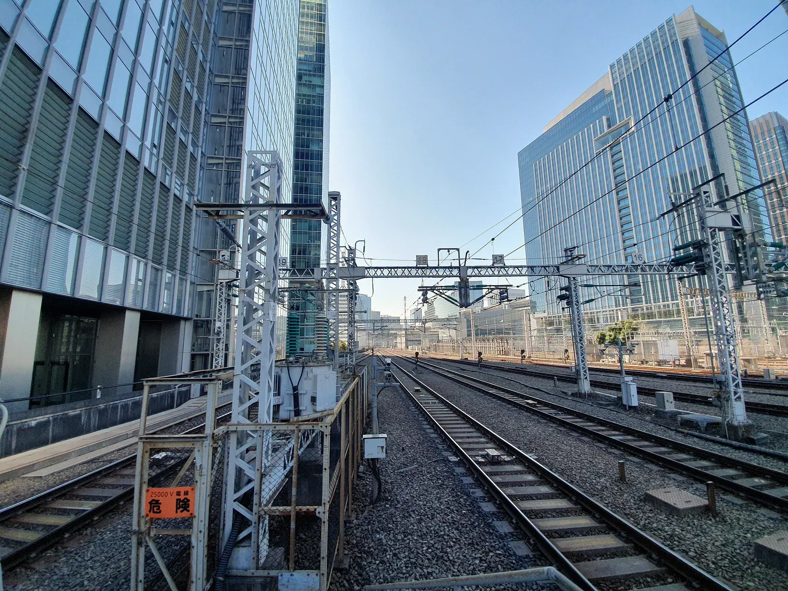 Railway tracks beside glass office towers in Tokyo